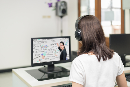 Asian woman student video conference e-learning with teacher on computer in IT room at university....