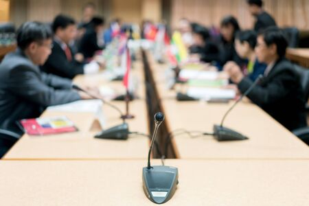 Microphone with blurred photo of conference hall or seminar room with attendee background, Business meeting concept.の写真素材