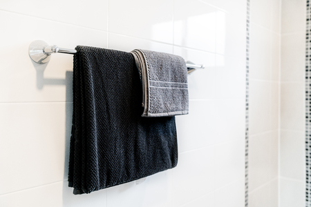 Interior of bathroom with black towel and rail at rail in bathroom.の写真素材