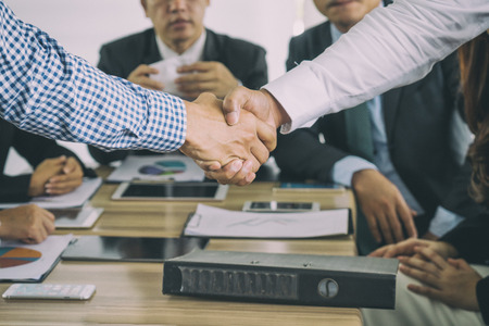 Asian businessman shaking hands in conference room. Business people shaking hands agreement concept.