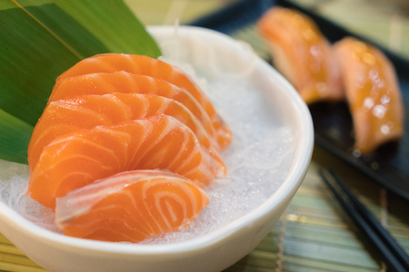 Raw salmon slice or salmon sashimi in Japanese style fresh serve on ice in bowl.の写真素材