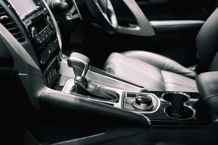 Luxury of car interior at transmission shift gear area. Modern car interior, gearstick radio and cup holder.の写真素材