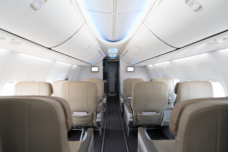 Empty passenger airplane seats in cabin. Interior in modern airplane.