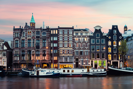 Night Amsterdam city view of Netherlands traditional houses with Amstel river in Amsterdam, Netherlandsの写真素材