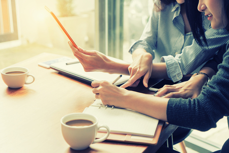 Two Asian business woman working together with digital tablet in office. Business team conceptの写真素材