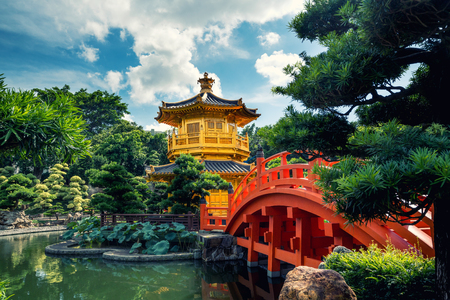 Front view the Golden pavilion temple with red bridge in Nan Lian garden, Hong Kong. Asia.