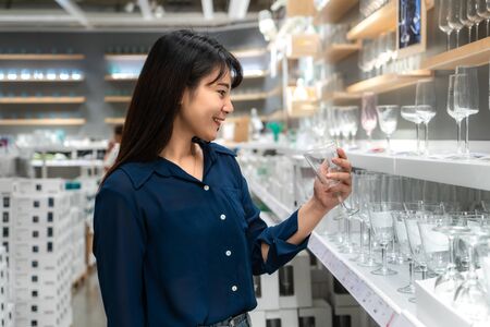Asian women are choosing to buy new glass in the mall. Shopping for groceries and housewares are needed in markets, supermarkets or big shopping centres.の写真素材