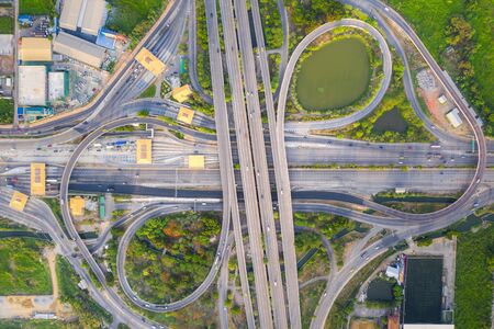 Aerial View Above of Busy Highway Road Junctions at day. The Intersecting Freeway Road Overpass The...