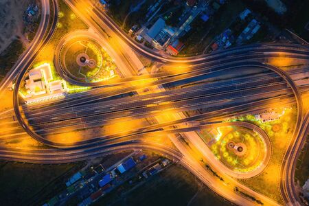 Aerial view of highway junctions Top view of Urban city, Bangkok at night, Thailand. Light trails...