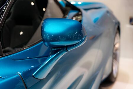 Side car mirror close-up. Details of blue car. Empty side rear view mirror concept with copy space.
