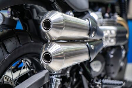 Close-up of exhaust or Intake of black sport racing Motorcycle with new tire and wheel in showroom. Low Angle Photograph Of Motorcycle.
の写真素材