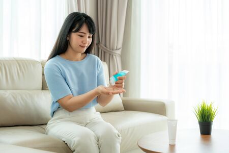 Asian womanl using alcohol antiseptic gel, prevention, cleaning hands frequently, prevent infection, outbreak of Covid-19 wash hands with hand sanitizer to avoid contaminating.の写真素材