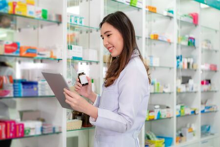 Asian woman pharmacy using video conference, make online consultation with patient consulting about illness and medication via video call. Telehealth, Telemedicine and online hospital.の写真素材