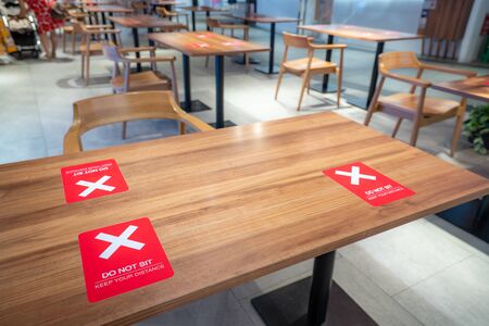 Social distancing rules one table per person in practice, alternate seating in local public food courts (cafe, restaurants, food outlets), to reduce risk of coronavirus COVID-19 Spread.の写真素材