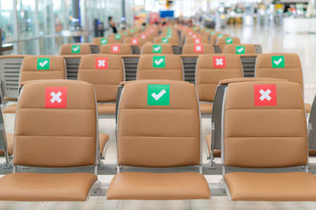 Social distance public chair layout during Covid-19 situation in airport terminal. Guideline for chair sharing. Keep safe from infection of the Virus.の写真素材