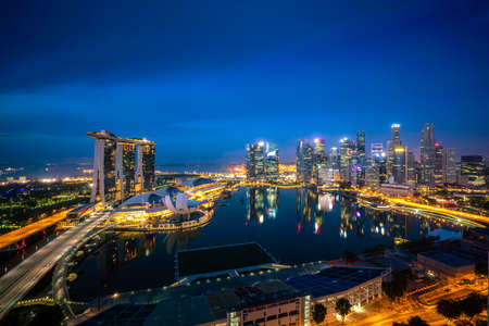 Panorama of Singapore business district skyline and office skyscraper at night in Marina bay, Singapore. Asian tourism, modern city life, or business finance and economy concept.のeditorial素材
