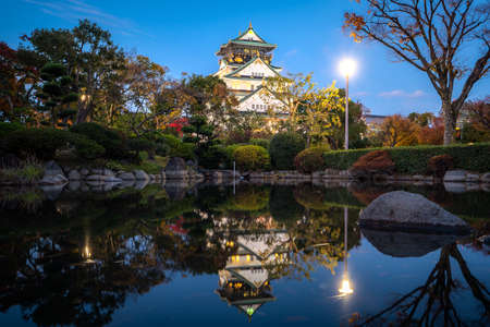 Osaka Castle with Japanese garden and reflection in pond at autumn season at night in Osaka, Japan. Japan tourism, history building, or tradition culture and travel conceptのeditorial素材