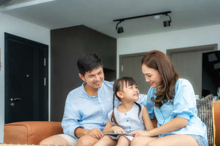 Happy Asian family with father, mother and daughter sitting on sofa and using digital tablet looking at screen together in living room at home.
Happy Asian family with father, mother and daughter sitting on sofa and using digital tablet looking at screen together in living room at home.の写真素材