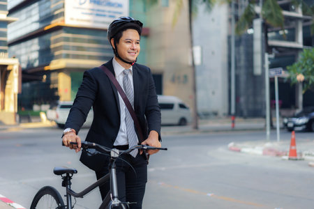 Asian businessman pushing his bicycle from home in the morning preparing to ride his bicycle to work. Eco tranportation.の写真素材