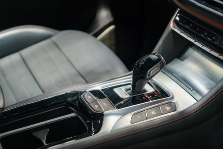 EV gear shift, a blend of form and function. Illuminated buttons beckon touch, promising seamless propulsion and futuristic driving.の写真素材