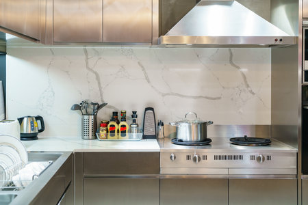 Interior shot of a modern kitchen. Featuring a sleek stove, a stylish sink, and a sophisticated...