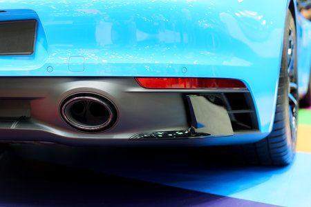 Intricate design of a sport car's exhaust pipe. This close-up view celebrates the precision and sophistication behind the vehicle's performance, emphasizing the sleek lines and dynamic form.の写真素材