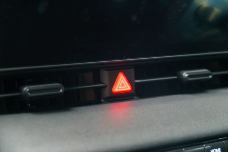 In the heart of modern automotive safety, a close-up reveals the crimson beacon of the emergency...