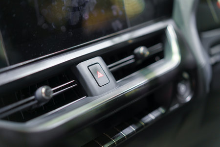 In the heart of modern automotive safety, a close-up reveals the crimson beacon of the emergency hazard light switch. Ready at a touch, this vital component stands as a beacon of preparedness, ensuring swift response to any roadside challengeの写真素材