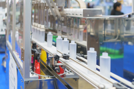 high-precision automated bottling system at work to efficiently fill and cap bottles in a...