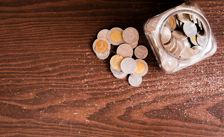saving coin on jar with wooden backgroundの写真素材