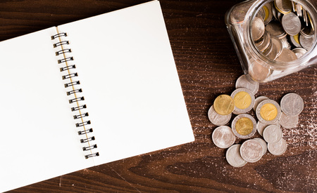 saving coin on jar with wooden backgroundの写真素材