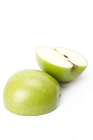 Green apple, two pieces of half green apple on white screen.の写真素材