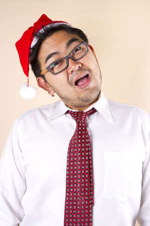 Hi Santa!, Businessman wear red hat and glasses smiling.の写真素材