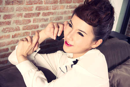 chat, female model chat on smart mobile phone smiling.の写真素材