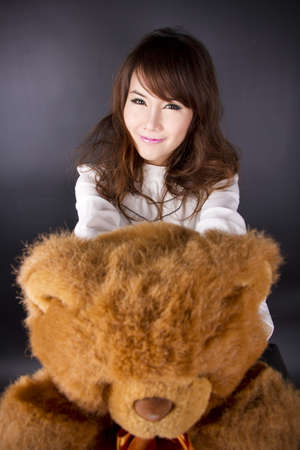 Happy Valentine, female model bring teddy bear for you.の写真素材