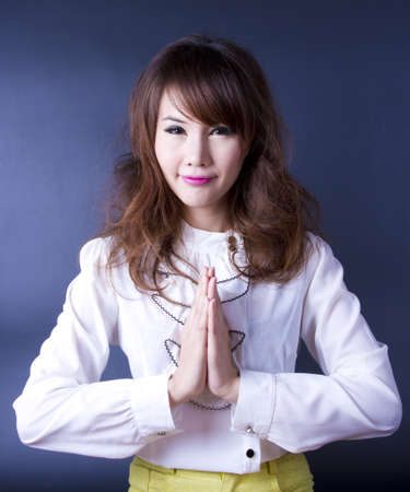 Sawasdee, Female model join own palms to make praying gesture.の写真素材
