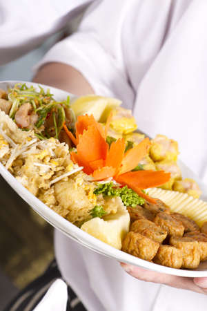 dish from chef, chef holding dish of Chinese style starter foodの写真素材