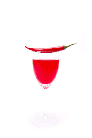 Chili juice, Long chili put on top of glass with red juice in glassの写真素材