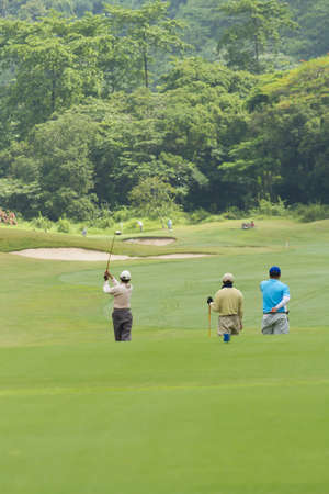 playing golf, golf player swing away his tee in gameのeditorial素材