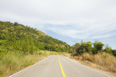 mountain road, yellow line on highway street curve along mountainの写真素材