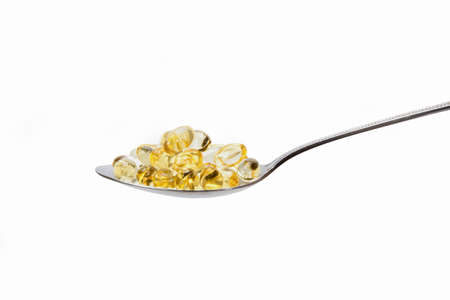 tablets in teaspoon, transparent yellow vitamin tablet with teaspoonの写真素材