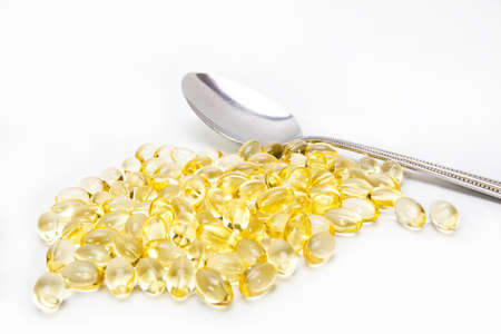 yellow tablets, transparent yellow vitamin tablet with teaspoonの写真素材