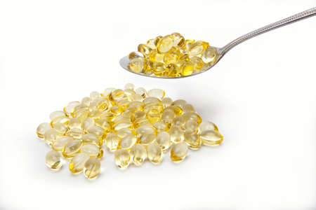 yellow vitamin, transparent yellow vitamin tablet with teaspoonの写真素材