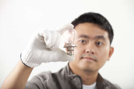 light bulb, Asian engineer man hold lighting bulb in his handの写真素材