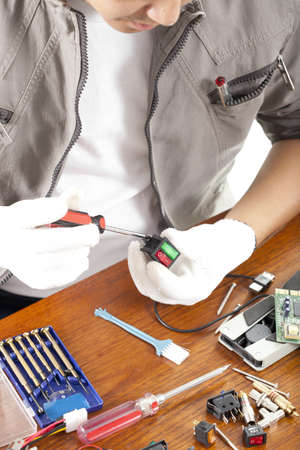 repair man, engineer fixing computer switch part on work table