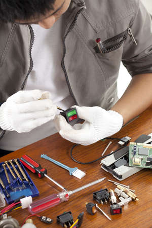 repair man, engineer fixing computer switch part on work tableの写真素材