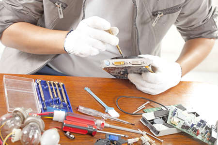 repair man, engineer fixing computer part on work table