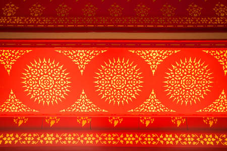 Thai paint, Golden drawing Thai style paint pattern with red backgroundの写真素材