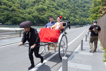 KYOTO, JAPAN - MAY 16  The married couple at Katsura shore on May 16, 2014 in Arashiyama, Kyoto, Japan  Arashiyama is well known as a pure environment area in Kyoto のeditorial素材