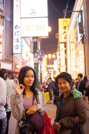 OSAKA, JAPAN - MAY 15 Tourist with smiling pose in night market on May 15, 2013 in Namba, OSAKA, Japan  Night market in Namba is a famous area in Osaka のeditorial素材